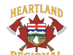 Heartland Regional Fire Issues Fire Advisory For County of Stettler Heartland Regional Fire Department emblem featuring a shield with mountains and fields, crossed axes, and a gold-edged banner reading Heartland above.