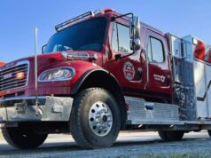 Stettler County Invests in New ‘BRAT’ Truck For Big Valley Fire Station Front-left view of a red fire engine with chrome bumper and diamond-plate detailing, parked outdoors.