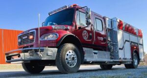 Stettler County Invests in New ‘BRAT’ Truck For Big Valley Fire Station Front-left view of a red fire engine with chrome bumper and diamond-plate detailing, parked outdoors.