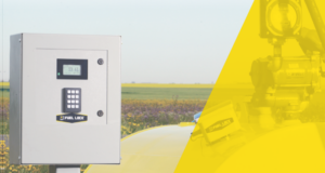 Stettler County Expands Diesel Storage To Prevent Fleet Delays Fuel-lock security cabinet with keypad mounted on a post beside a field, with a yellow tinted overlay on the right.