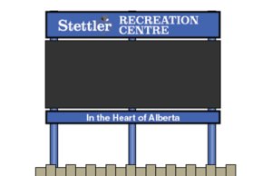 Town of Stettler Awards $68K Contract For New Recreation Centre Digital Sign Outdoor sign for Stettler Recreation Centre, with a blue header and posts, showing the slogan 'In the Heart of Alberta' on a wooden fence backdrop.
