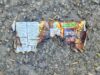 ‘Sounded Like Gunshots’: Fireworks Dropped From Vehicle Hit Stettler Neighbourhood Burnt fireworks wrapper with a Jackpot slot-machine graphic on a rocky, gravel surface.