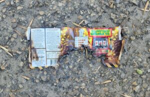 ‘Sounded Like Gunshots’: Fireworks Dropped From Vehicle Hit Stettler Neighbourhood Burnt fireworks wrapper with a Jackpot slot-machine graphic on a rocky, gravel surface.