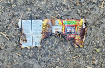 ‘Sounded Like Gunshots’: Fireworks Dropped From Vehicle Hit Stettler Neighbourhood Burnt fireworks wrapper with a Jackpot slot-machine graphic on a rocky, gravel surface.