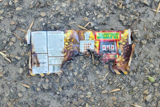 ‘Sounded Like Gunshots’: Fireworks Dropped From Vehicle Hit Stettler Neighbourhood Burnt fireworks wrapper with a Jackpot slot-machine graphic on a rocky, gravel surface.