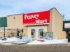 Stettler Home Hardware Moving To Vacant Peavy Mart Location In 2027 Peavey Mart storefront on a beige brick building with a large red sign, snow in the parking lot in front.