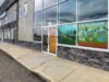 Stettler County Recommends Higher Fire Response Fees For Heartland Commission Commercial storefront with large glass windows displaying 'FIRE PREVENTION' posters and safety graphics outside a building exterior.