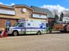 Area Youth Get Hands-On Experience at Stettler Skills Day Emergency response scene outside the SALC building with an ambulance and a ladder fire truck as firefighters work on site nearby.