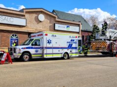 Area Youth Get Hands-On Experience at Stettler Skills Day Emergency response scene outside the SALC building with an ambulance and a ladder fire truck as firefighters work on site nearby.